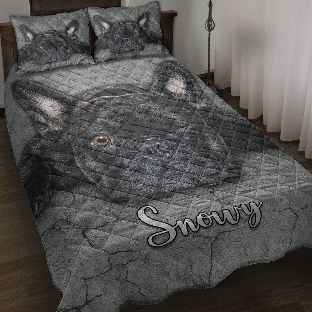French Bulldog quilt blanket displayed on a bed with a large black Frenchie portrait and gray cracked-stone artwork