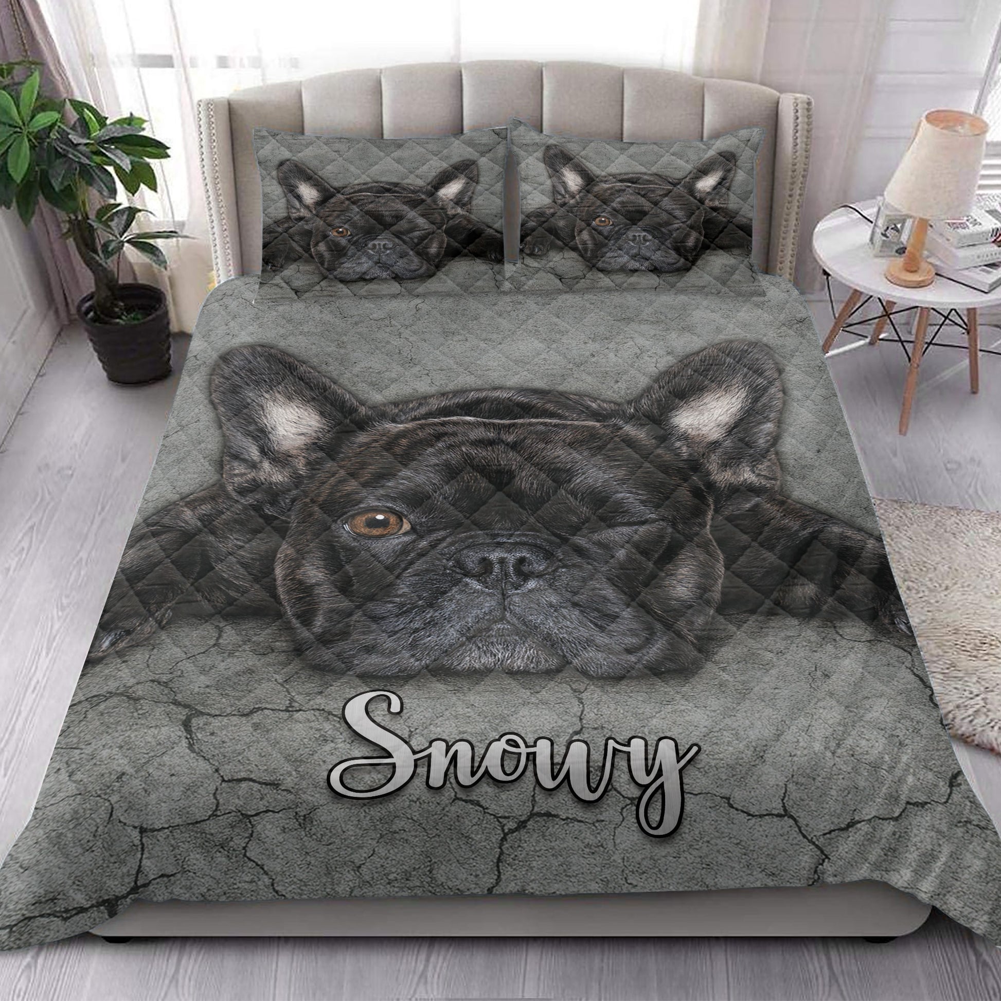 French Bulldog quilt bedding styled in a bright bedroom with a large black Frenchie portrait across the blanket