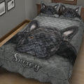 Gray French Bulldog quilt blanket displayed on a wooden bed with black Frenchie portraits and textured artwork