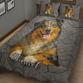 Close view of Australian Shepherd dog artwork across a gray quilt blanket and pillowcases