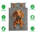 Dachshund quilt bedding display with brown dog artwork, gray diamond quilting, and feature icons