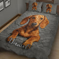 Gray dachshund quilt blanket shown on a bed with close-up brown wiener dog artwork and matching pillows