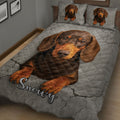 Close angled view of dachshund quilt bedding with a warm brown dog portrait and gray cracked-stone pattern