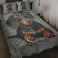 Dachshund quilt bedding set displayed on a bed with a large black and tan dog portrait