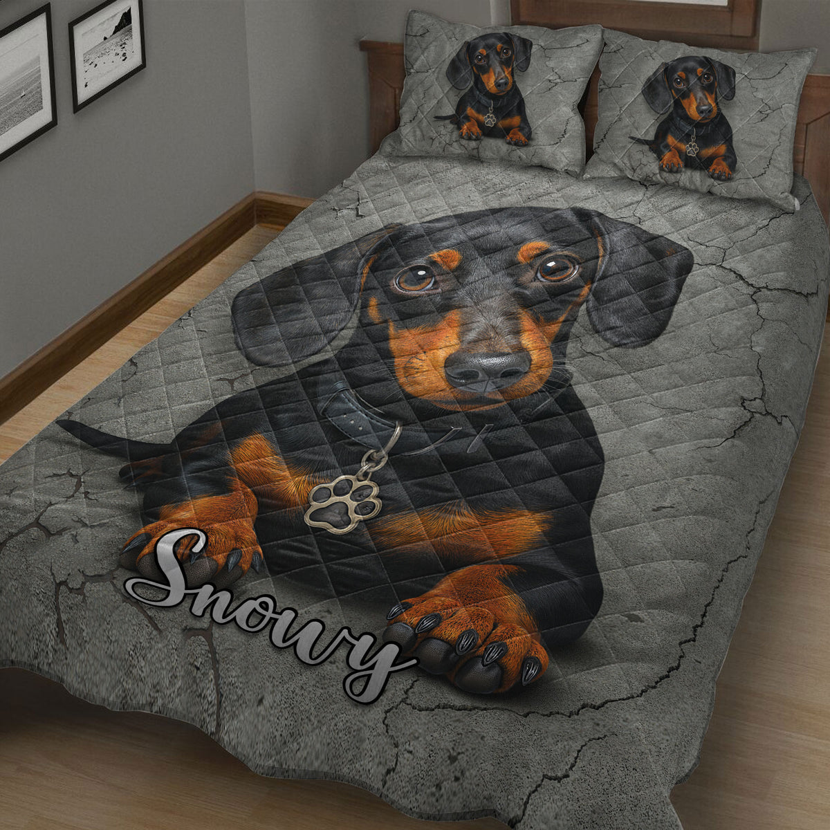 Close view of black and tan dachshund artwork across a quilted bedspread