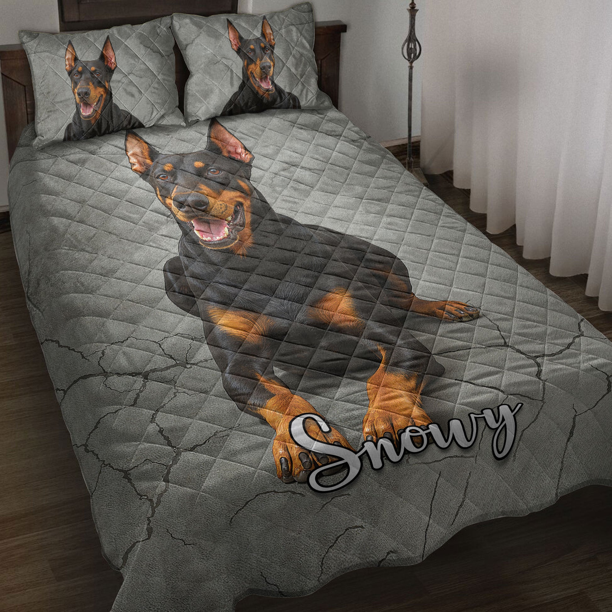 Doberman quilt blanket spread across a bedroom with matching dog artwork on the pillows