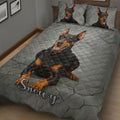Close bedroom view of a Doberman quilt blanket with large black and tan dog artwork