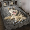 Husky quilt blanket displayed on a bed with matching husky artwork and gray stone-textured background