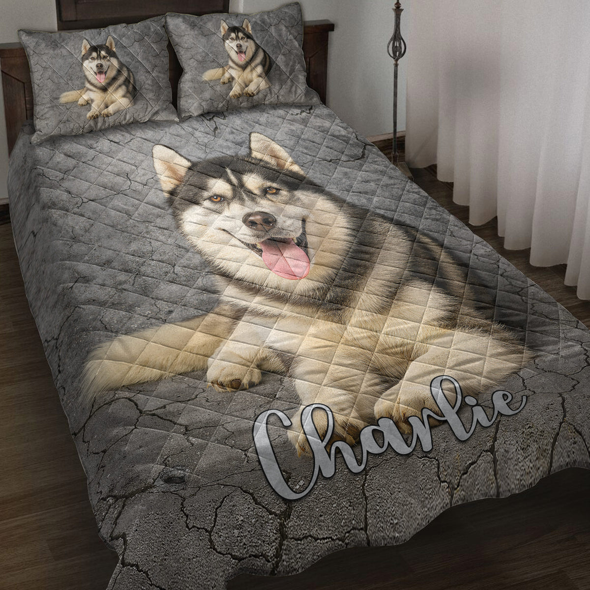 Husky quilt blanket displayed on a bed with matching husky artwork and gray stone-textured background