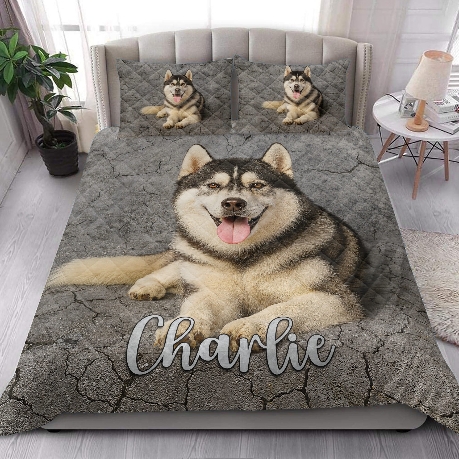 Husky quilt bedding styled in a bright bedroom with a large dog portrait and gray stone background