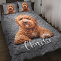 Poodle quilt blanket displayed on a bed with matching dog portraits on the pillows
