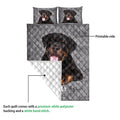 Rottweiler quilt showing the printed front and white quilted backing in a product construction view