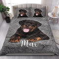 Rottweiler quilt blanket styled on a modern bedroom bed with large dog portrait artwork
