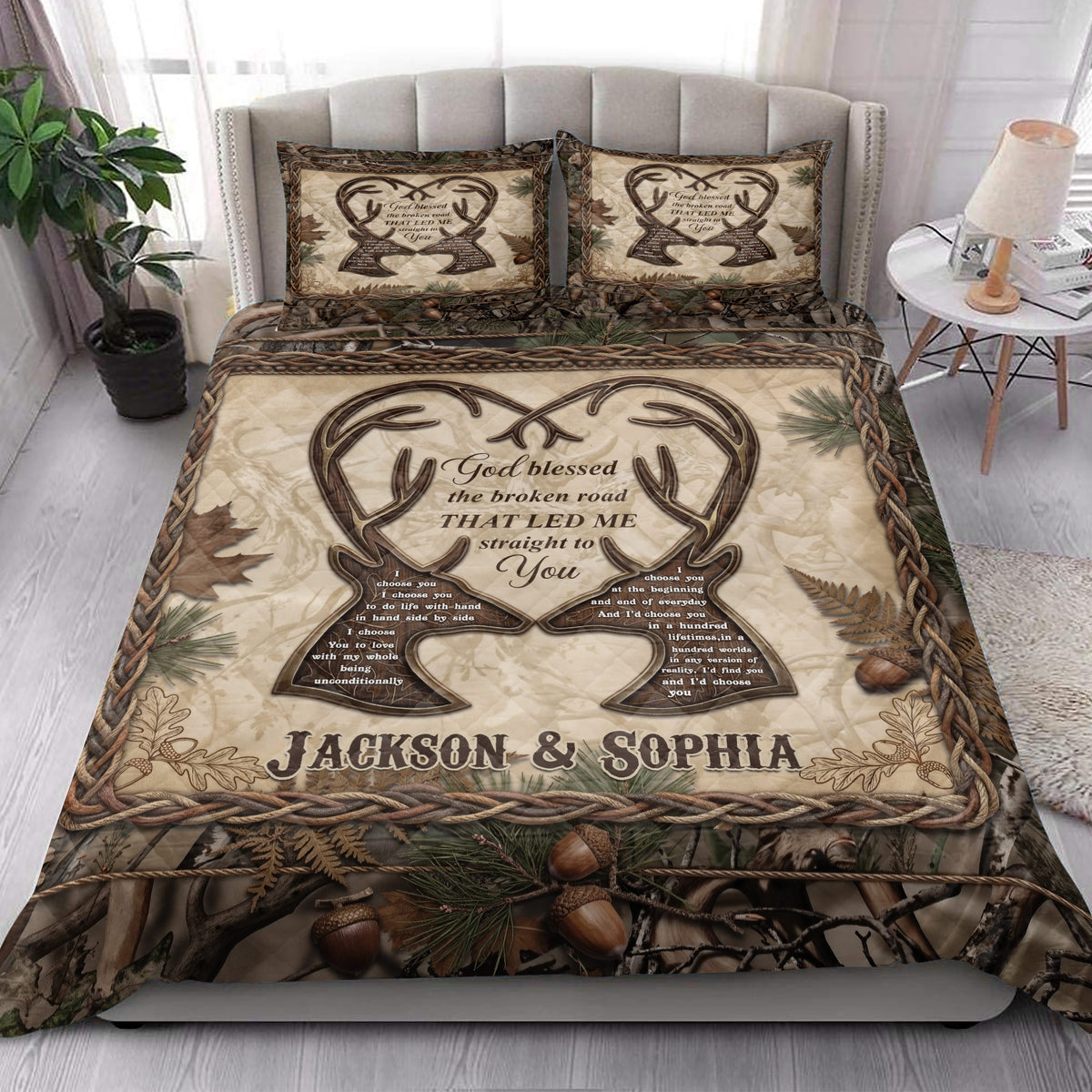 Rustic hunting quilt blanket styled in a bright bedroom with deer antlers, pine branches, acorns, and camouflage