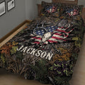 Close-up hunting quilt blanket featuring paired deer skulls, antlers, forest textures, and patriotic outdoor artwork