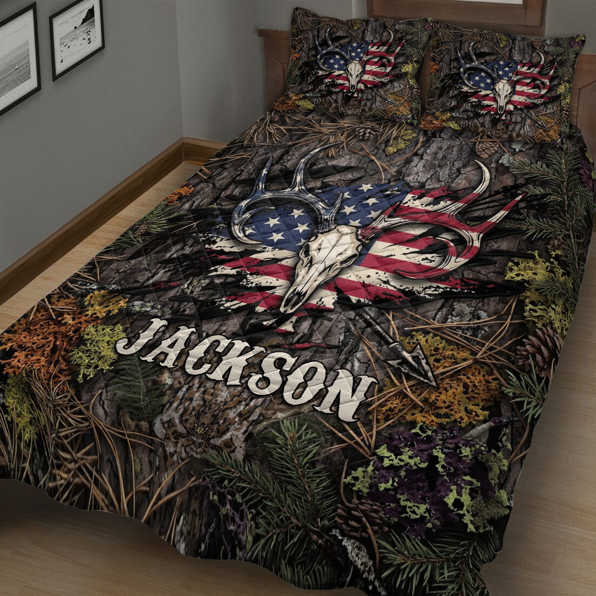 Close-up hunting quilt blanket featuring paired deer skulls, antlers, forest textures, and patriotic outdoor artwork
