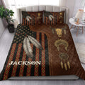American Native quilt blanket styled on a bed with feathers, dreamcatchers, geometric patterns, and bison skull artwork