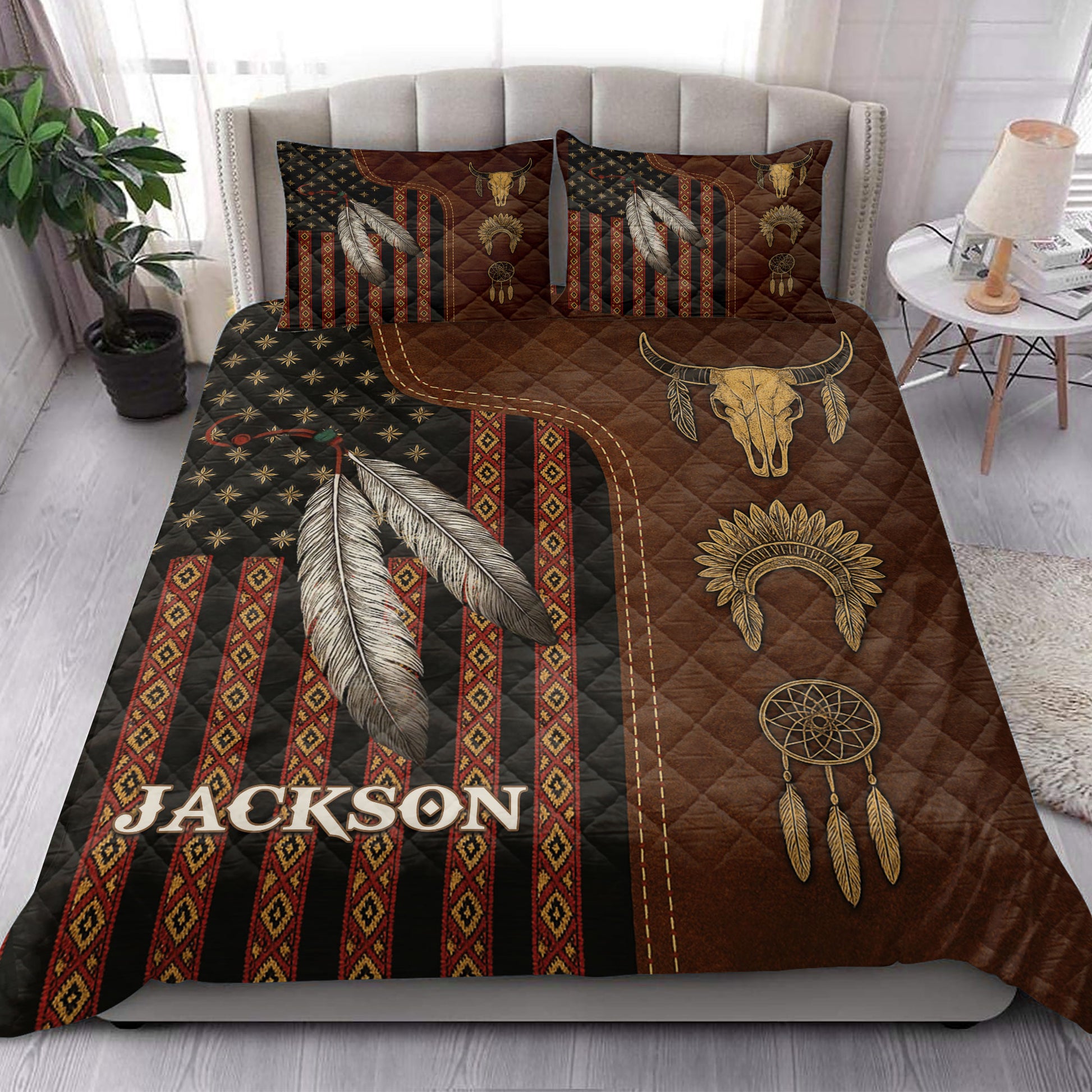 American Native quilt blanket styled on a bed with feathers, dreamcatchers, geometric patterns, and bison skull artwork