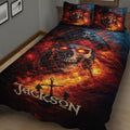 Close bedroom view of a pirate quilt blanket with glowing skull artwork, red flames, anchor details, and matching pillows
