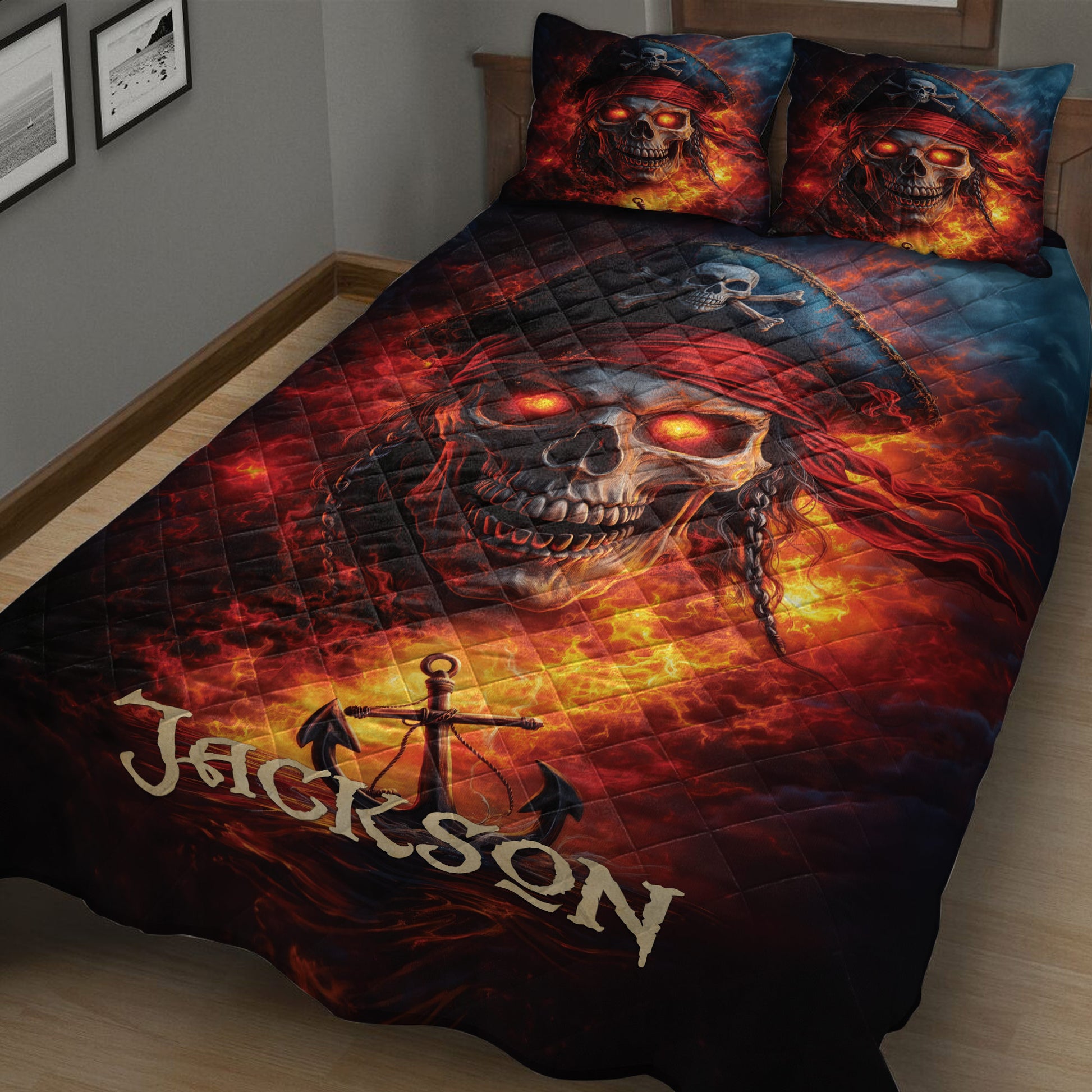 Close bedroom view of a pirate quilt blanket with glowing skull artwork, red flames, anchor details, and matching pillows