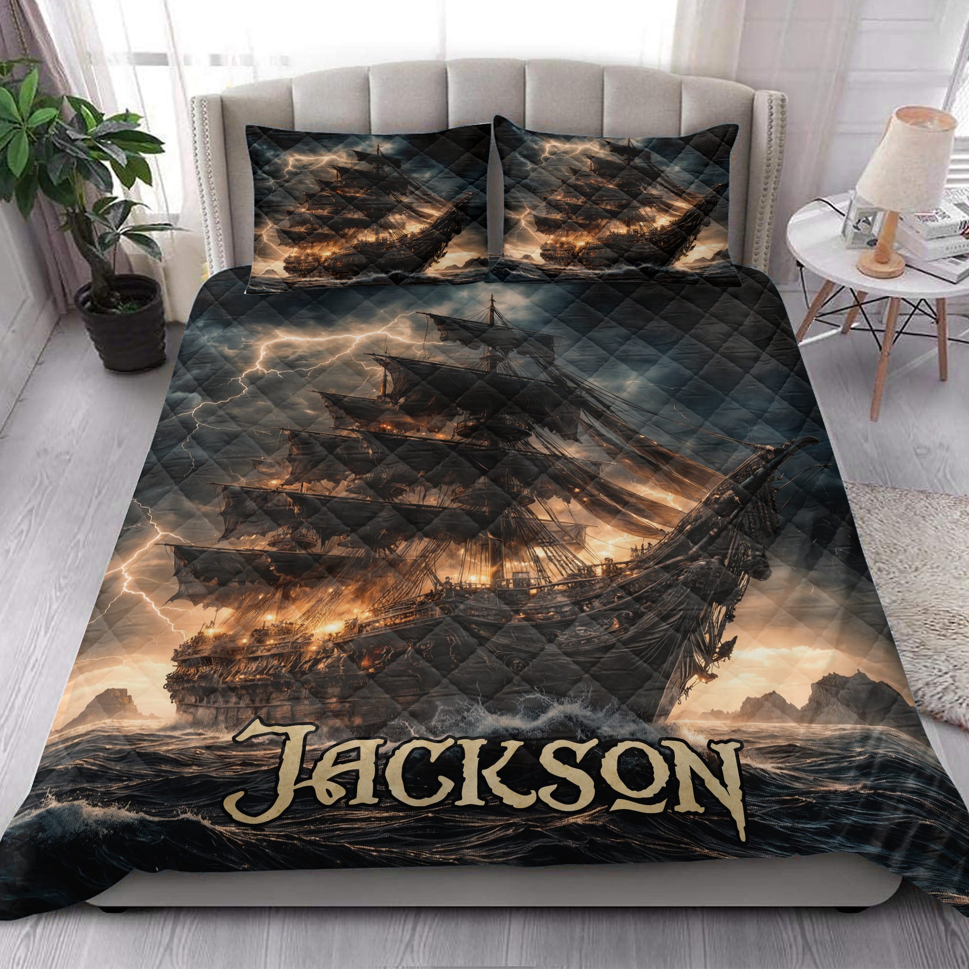 Pirate ship quilt blanket styled in a bedroom with stormy ocean artwork and dramatic dark nautical decor