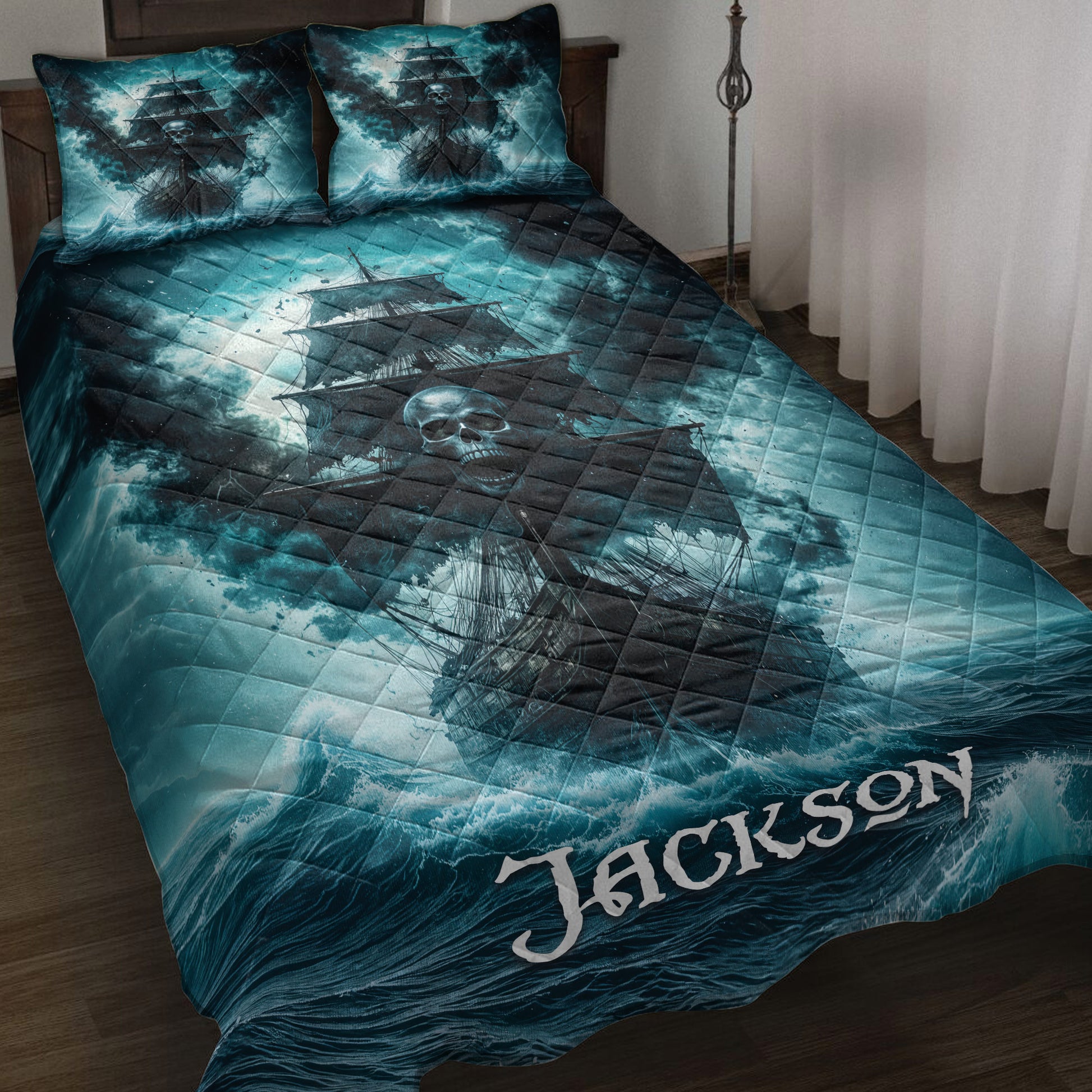 Pirate quilt blanket displayed on a bed with skull ship artwork, stormy teal seas, and matching pillow designs
