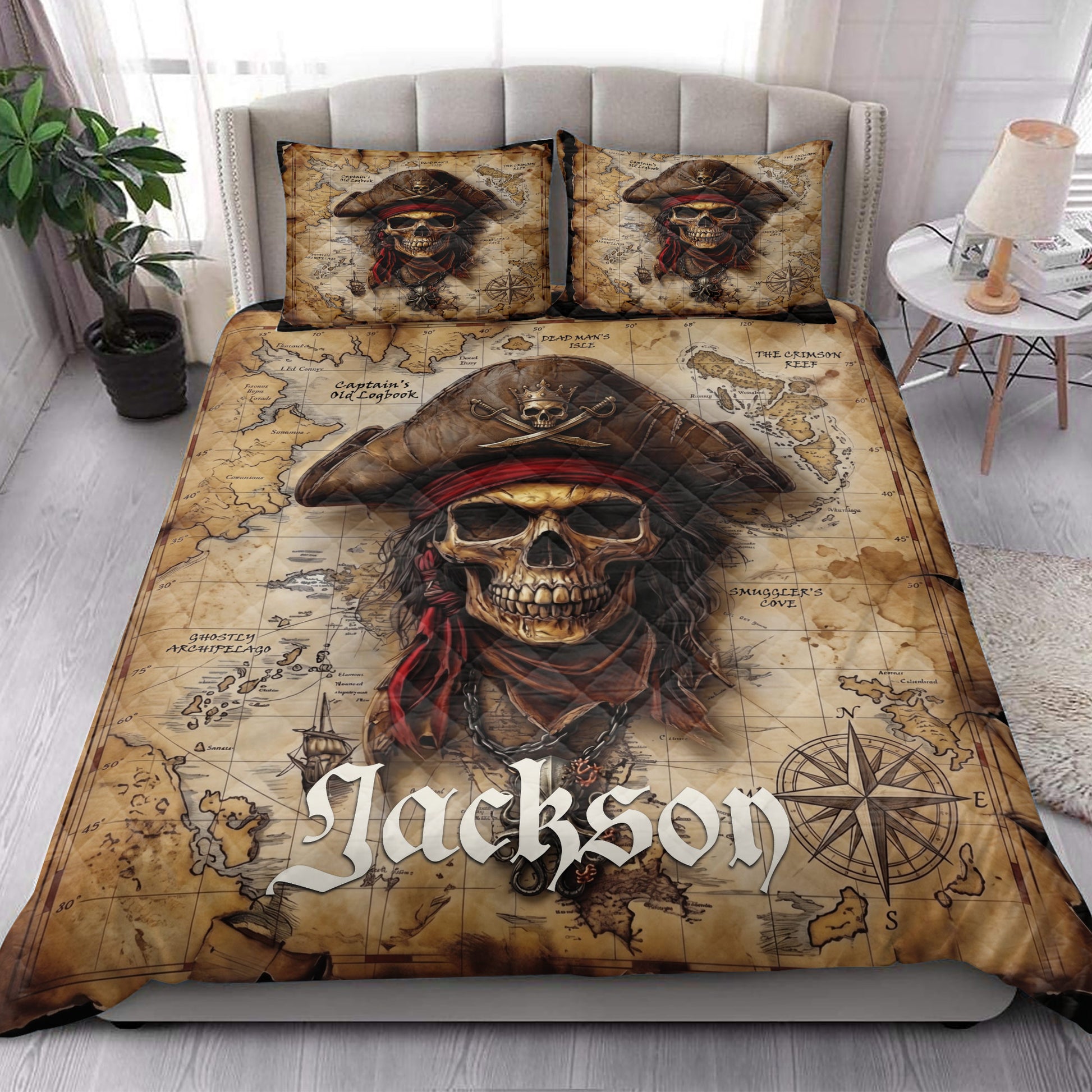 Pirate quilt blanket styled in a bright bedroom with skull captain artwork, map details, and nautical compass accents