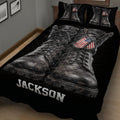 Close view of black veteran quilt blanket with weathered combat boots and patriotic dog tags