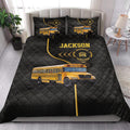 School bus driver quilt blanket styled on a bedroom bed with bold yellow bus graphics and black bedding details