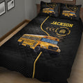School bus quilt blanket displayed in a bedroom with large yellow bus artwork and black geometric background
