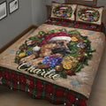 Close-up of a Christmas German Shepherd quilt blanket featuring holiday gifts, greenery, snowflakes, and plaid borders