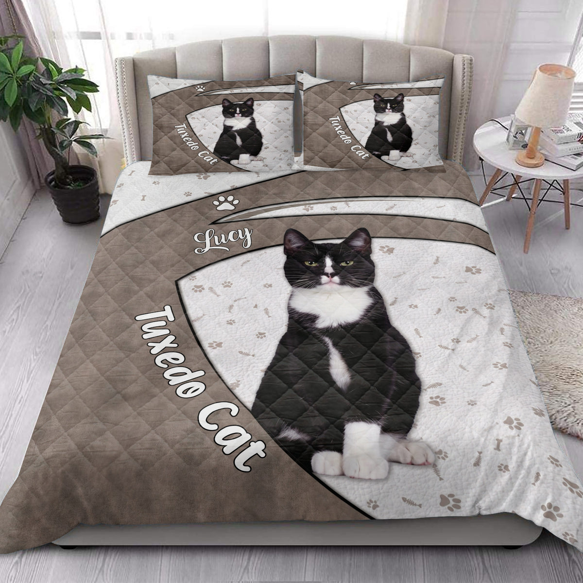 Tuxedo cat quilt blanket styled in a bright bedroom with matching cat artwork on the bed