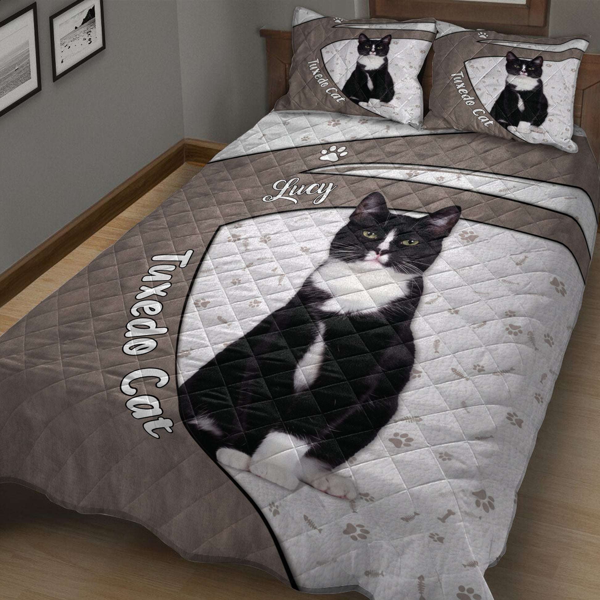 Close bedroom view of a tuxedo cat quilt blanket with black-and-white cat artwork and paw print details