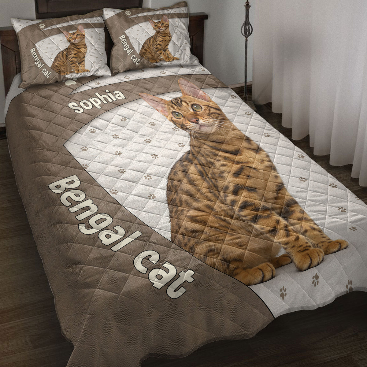 Bengal cat quilt blanket displayed on a bed with paw prints, brown accents, and matching cat artwork