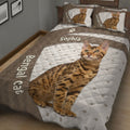 Close view of a Bengal cat quilt blanket featuring a reclining spotted cat, paw prints, and brown bands