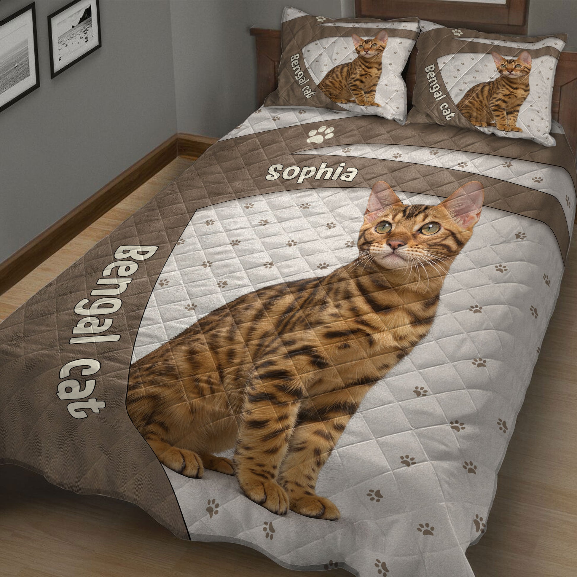 Close view of a Bengal cat quilt blanket featuring a reclining spotted cat, paw prints, and brown bands