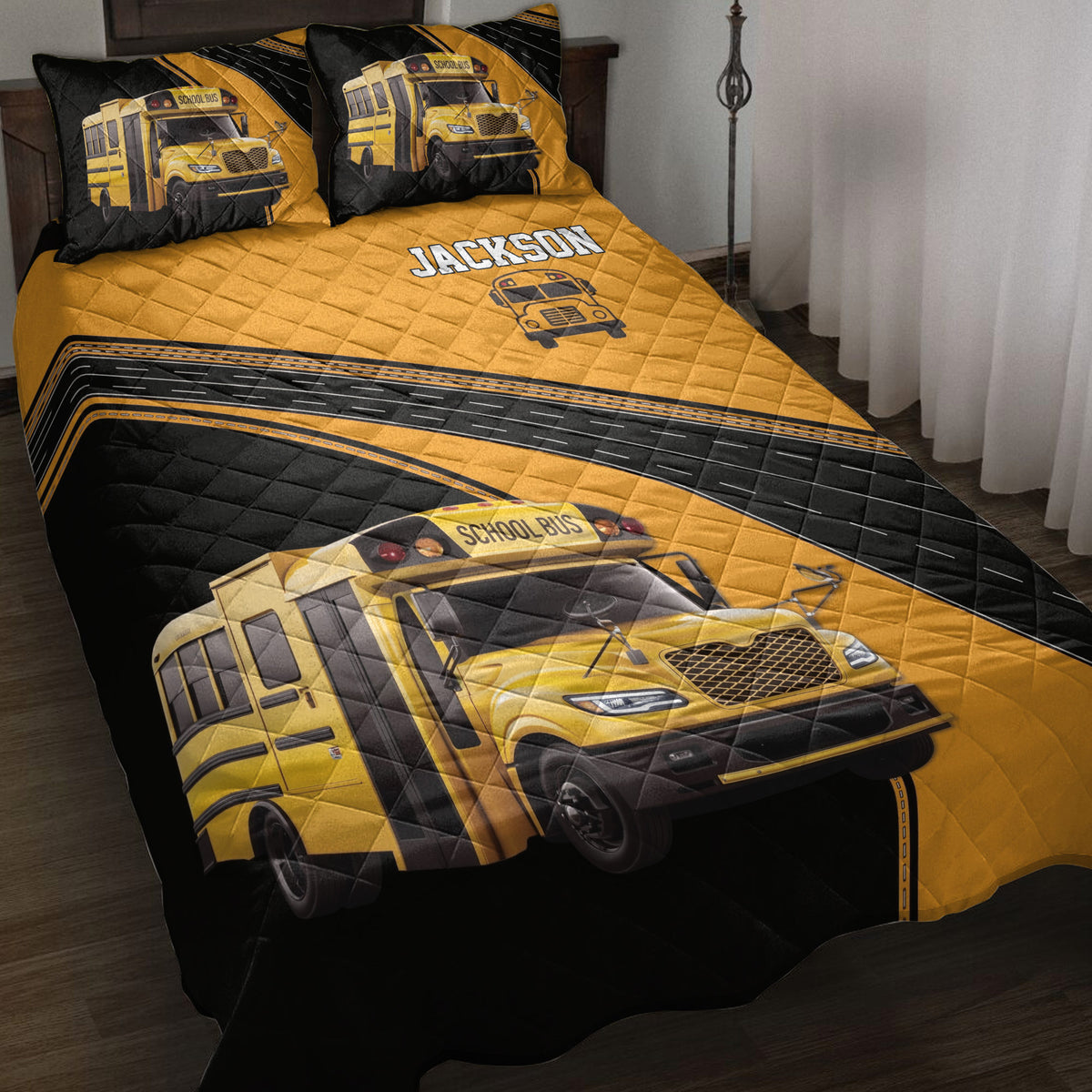School bus driver quilt blanket displayed on a bed with yellow buses, black road graphics, and bold custom artwork