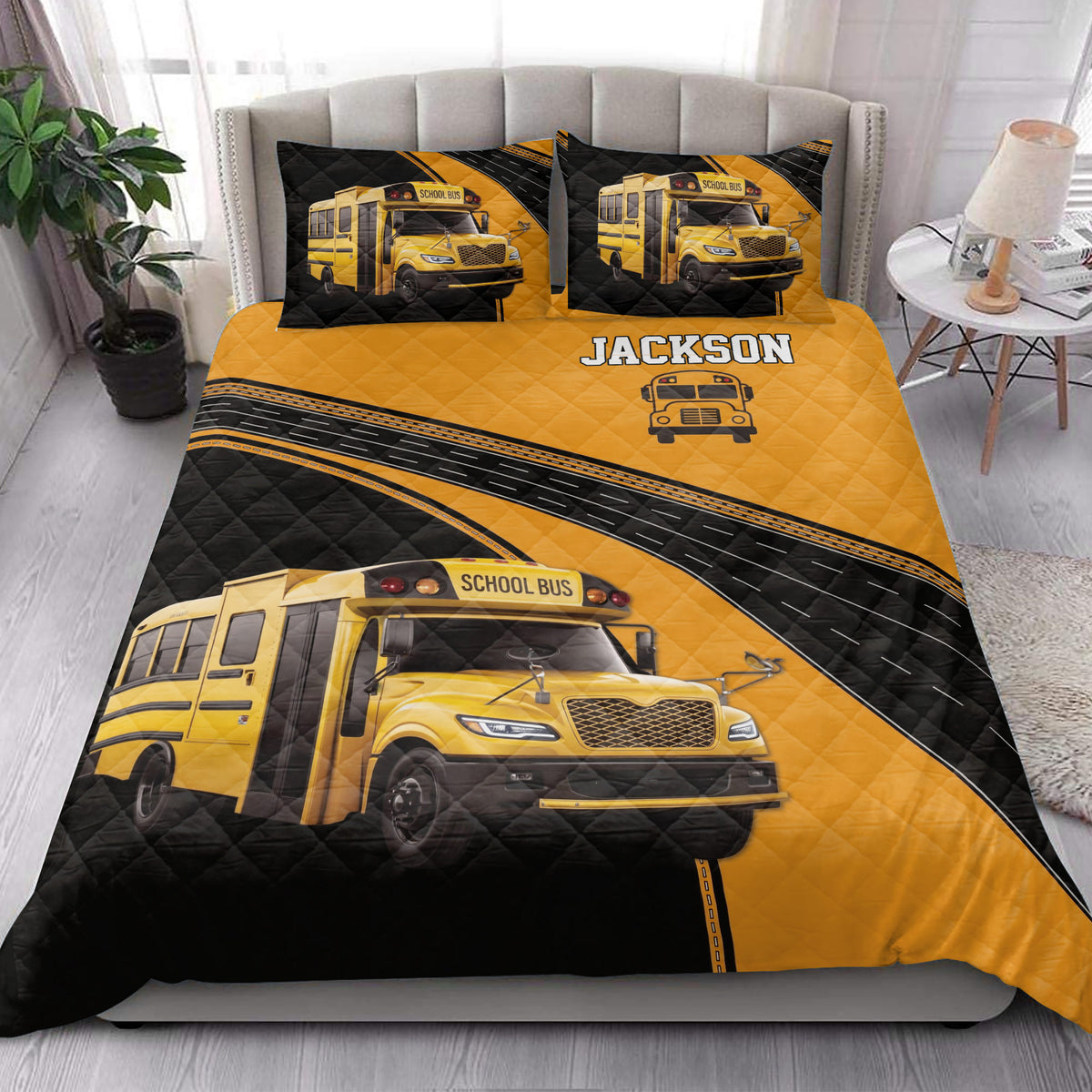 School bus driver quilt blanket styled in a bright bedroom with yellow bus artwork and black road accents