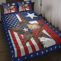 Texas quilt blanket displayed on a bed with a western star, red white and blue stripes, and navy star border