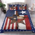 Texas quilt bedding set styled in a bright bedroom with western star artwork and patriotic red white and blue colors