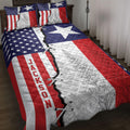 Texas Lone Star quilt blanket displayed on a bed with patriotic stars, stripes, and floral artwork