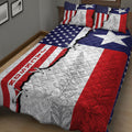 Texas patriotic quilt blanket displayed on a bed with stars, stripes, and detailed floral panels