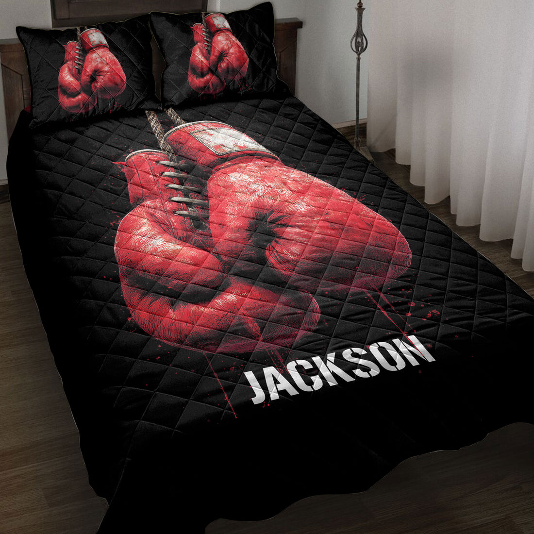 Black boxing quilt blanket displayed on a bed with bold red boxing gloves artwork