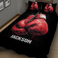 Close angled view of black boxing quilt blanket with dramatic red glove artwork