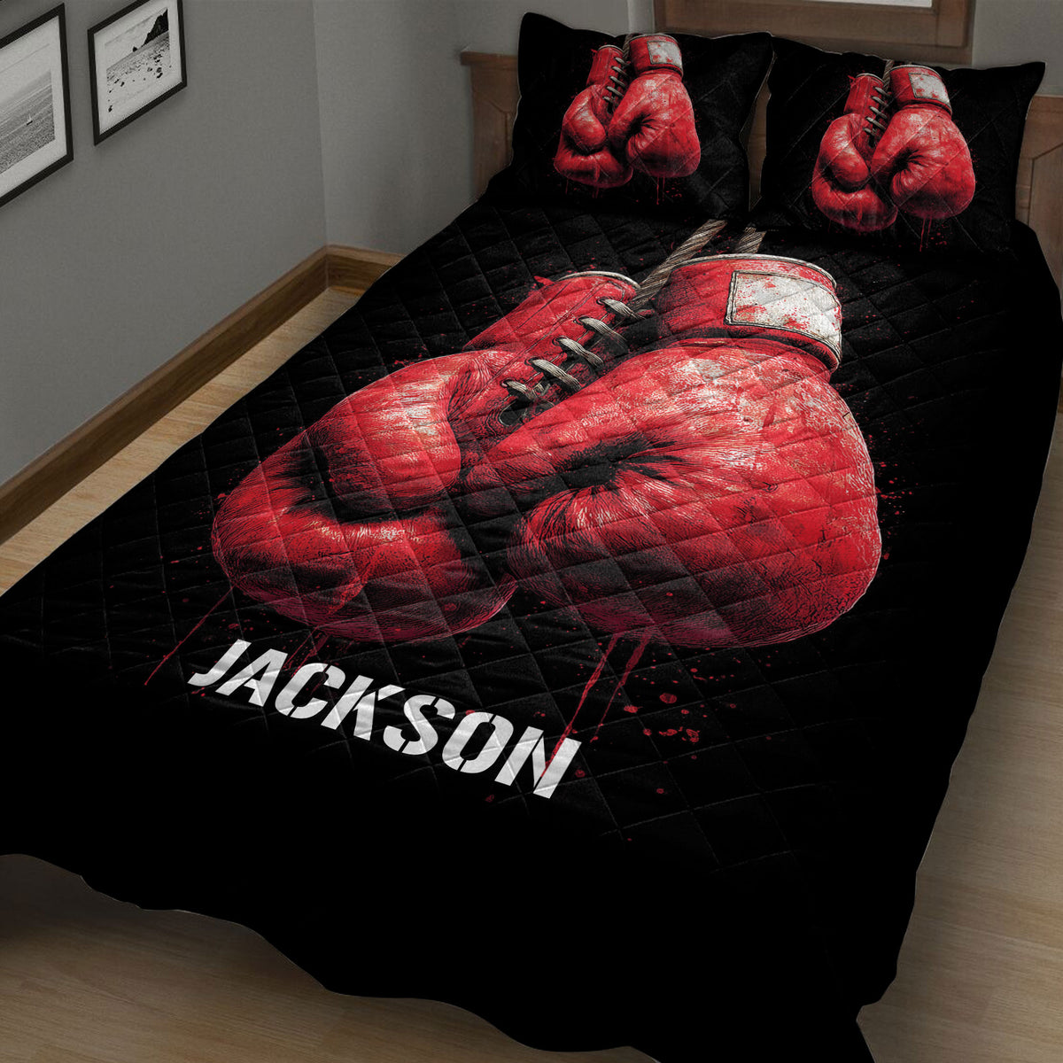 Close angled view of black boxing quilt blanket with dramatic red glove artwork