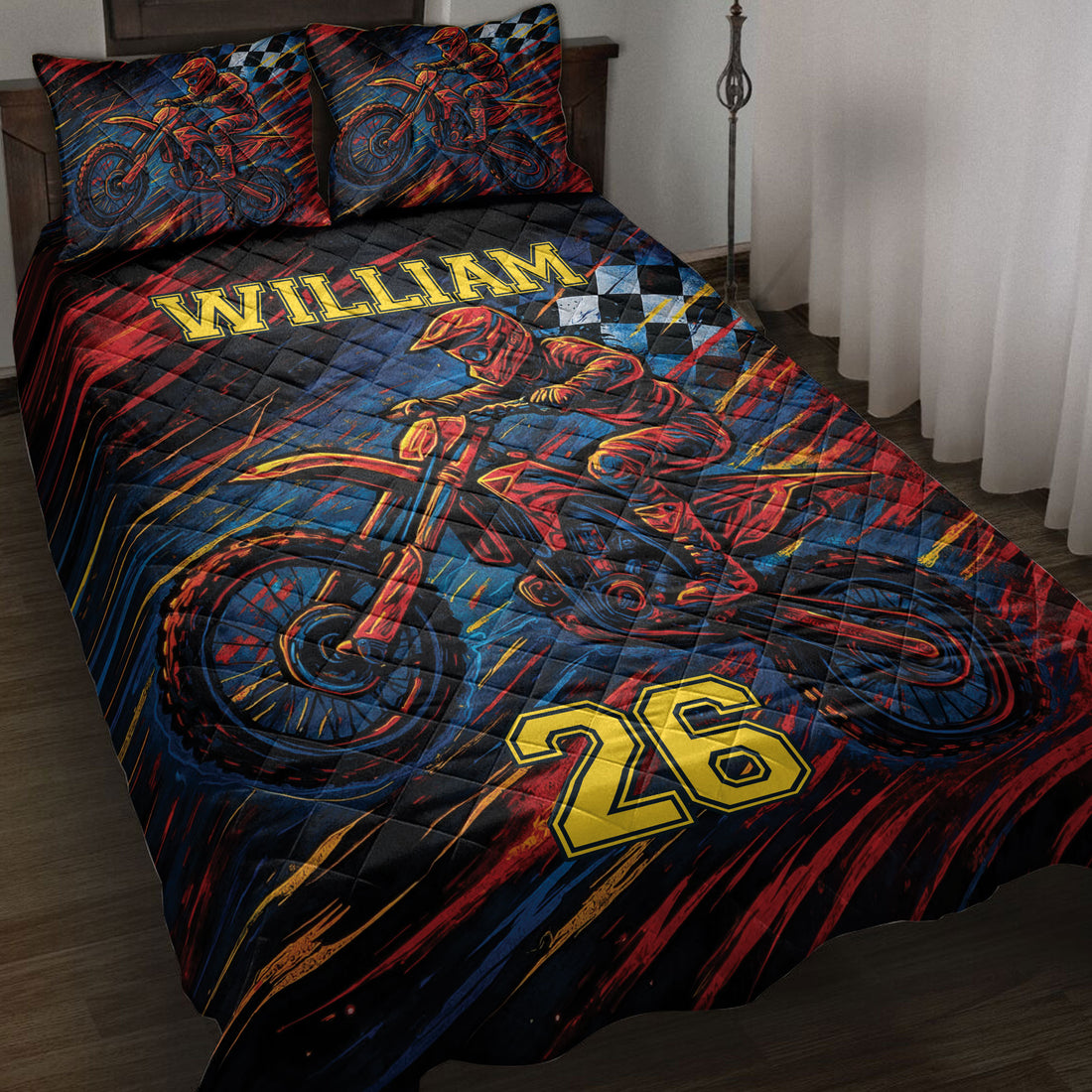 Motocross quilt blanket displayed on a bed with dirt bike rider artwork in red, blue, black, and gold