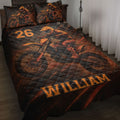 Motocross quilt bedding set displayed on a bed with orange dirt bike rider artwork and bold black styling