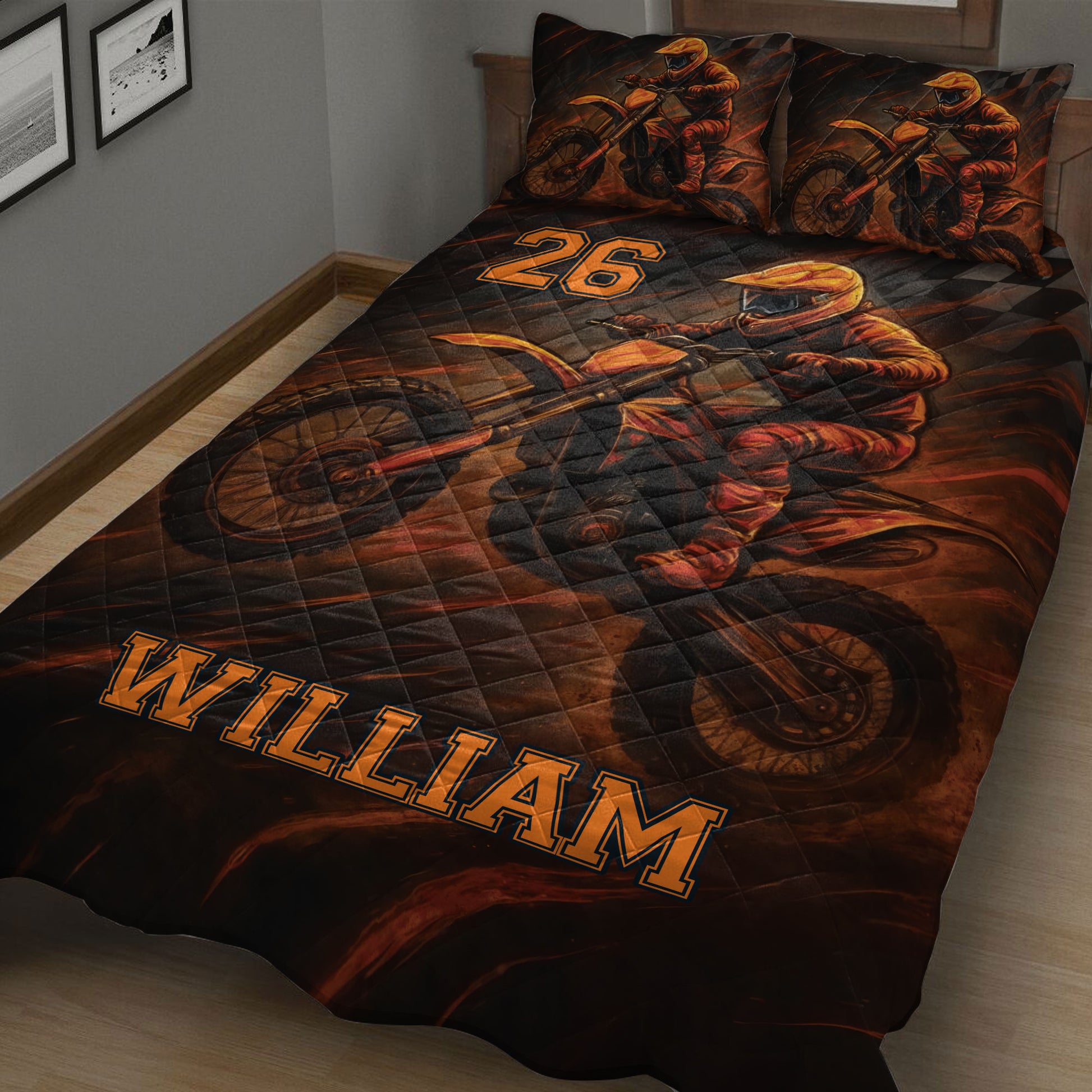 Motocross quilt blanket displayed on a bed with dynamic dirt bike racing artwork in black and orange