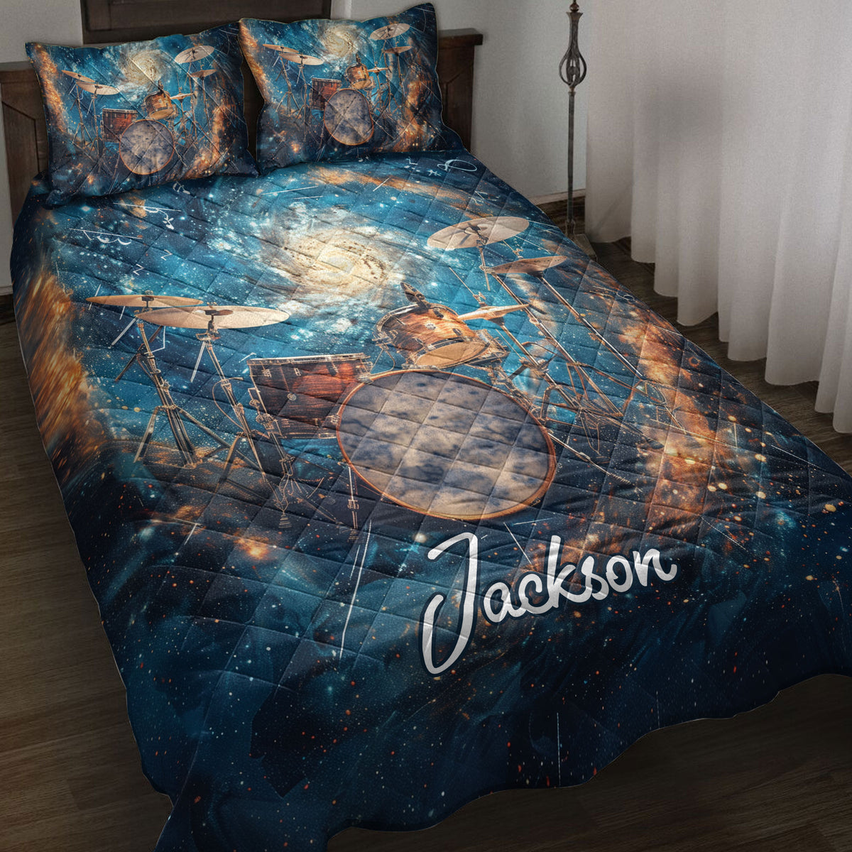 Drum quilt blanket displayed on a bed with cosmic artwork, cymbals, and a vivid blue music theme