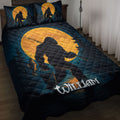Bigfoot quilt blanket displayed on a bed with a fishing Sasquatch silhouette, moonlit forest, and deep blue artwork